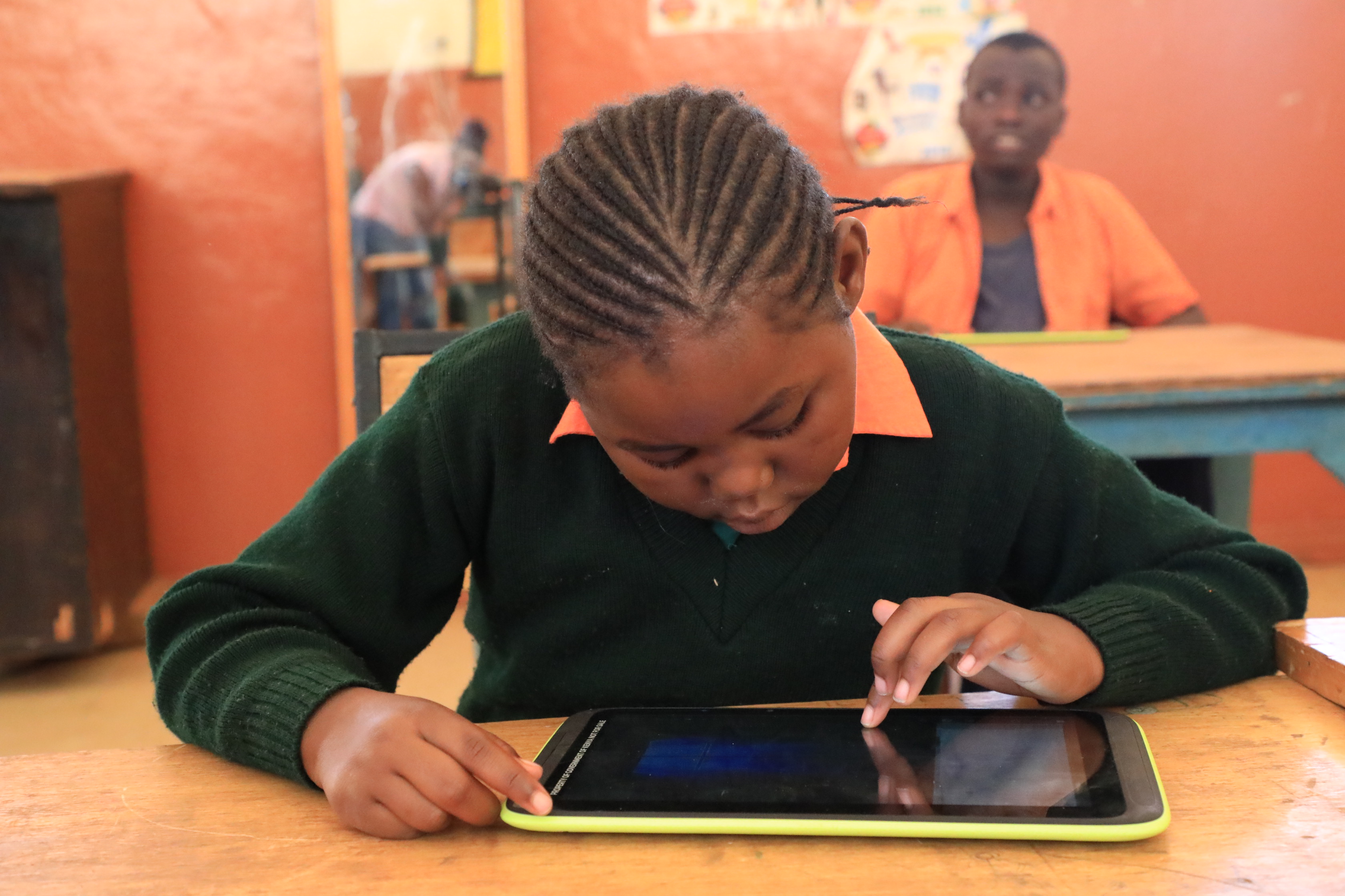 Children using the digital accessible textbook in a classroom in Kenya