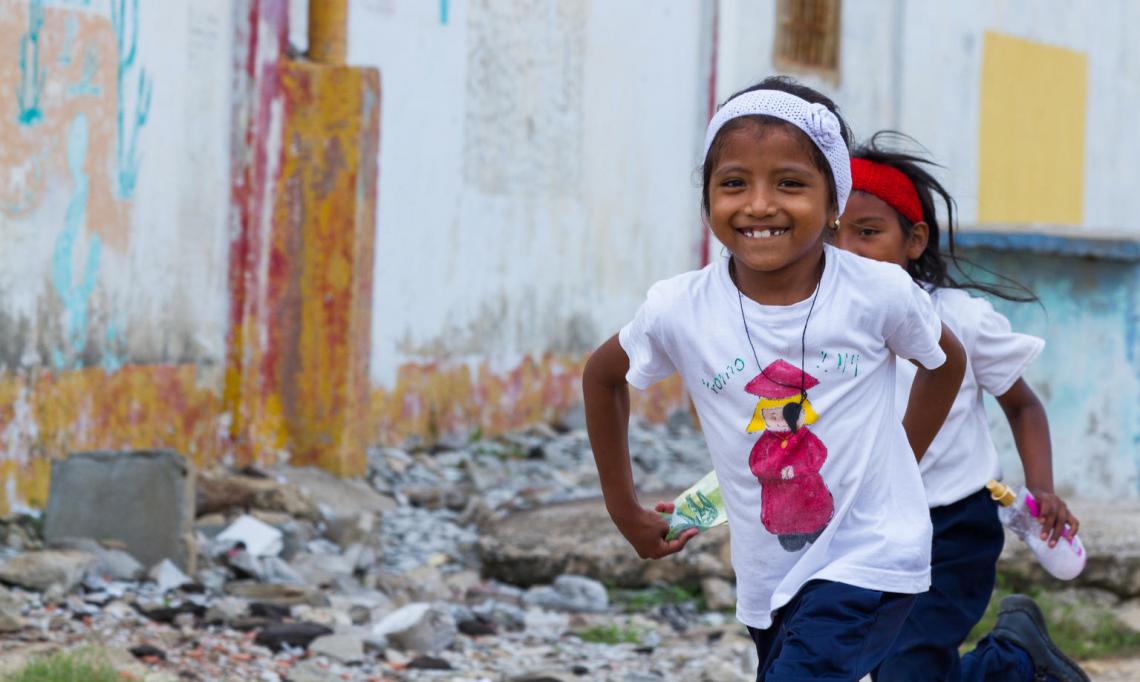 Two girls running in Guarero, Zulia, Venezuela.